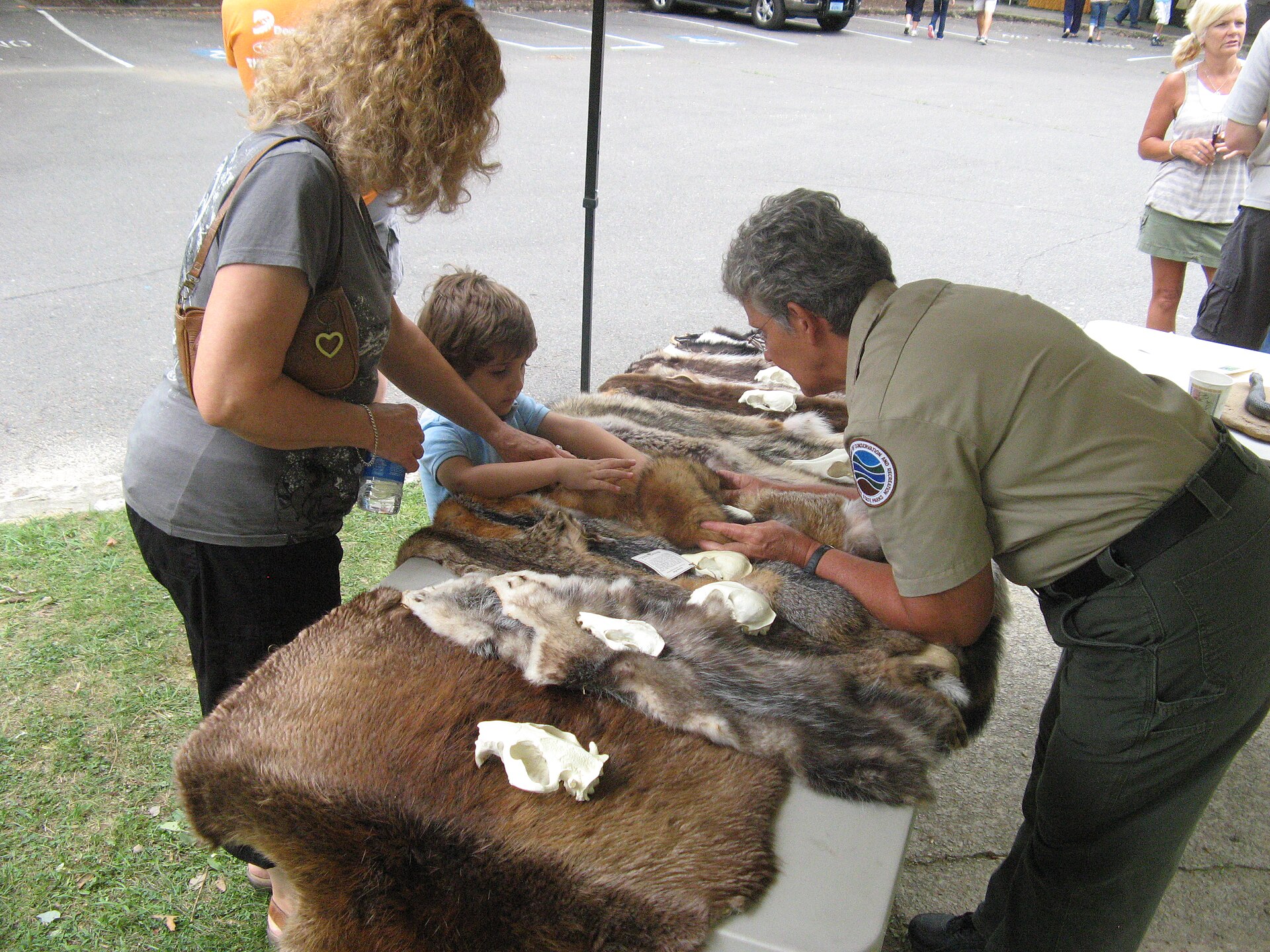 A craft maker showing handmade work to visitors at an arts and crafts festival
